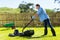 Young man mowing lawn