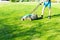 Young man mows the lawn