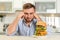 Young man near huge burger on table