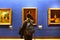 Young man observing a picture in Uffizi museum