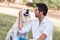 Young man with old senior labrador dog in the park