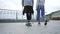 Young man with one leg on crutches riding on skateboard walking with his girlfriend. Active life of disabled person. The