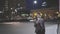 A young man in the open-air with a cellphone at night