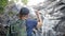 Young Man Open Arms to Amazing Jungle Waterfall Expressing Happiness and Freedom. Beautiful Thailand Nature.