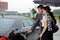 Young man opening door of car for woman