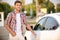 Young man opening his car