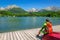 Young man with orange backpack on red boat