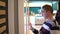 A young man orders food at the touch terminal in a shopping center. Modern technology. On the food court without waiting