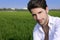 Young man outdoor happy in green meadow