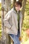 Young Man Outdoors Walking In Autumn Woodland