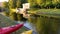 A young man with a paddle floats on a yellow kayak.