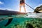 Young man on paddleboard, half under and half above water compos