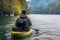 Young man is paddling a canoe on forest river.