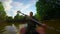 Young man paddling canoe on river. Action camera, slowmotion