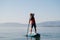 Young man paddling on sup board