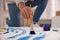 Young man painting on canvas with brush in artist studio, closeup