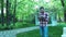 A young man in the park using a tablet is engaged in business. Portrait of a student leaning against a tree while using