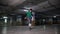 A young man performing professional football tricks on the underground parking