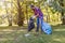 Young man picking up litter in his local park