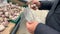 Young man picks up garlic in a plastic bag