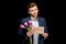 Young man with pink tulips and sorry sign hopefully looking at camera