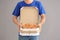 Young man with pizza boxes on grey background. Food delivery service