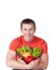 Young man with plate of fresh healthy vegetables