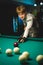 Young Man Playing Billiards Lined Up To Shoot Easy Winning Shot