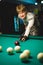 Young Man Playing Billiards Lined Up To Shoot Easy Winning Shot