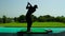 Young man playing golf in the shadow