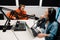 Young man playing guitar while woman recording podcast in radio studio