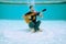 Young Man Playing Music With Guitar And Singing Song Underwater