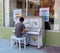 A young man playing a piano outside an art gallery in southern ontario