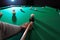 Young man playing Russian billiard indoors