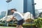 Young man playing tennis outdoors in a modern district of the city