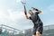 Young man playing tennis at tennis and serving a ball with straighten strike.