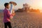 Young man playing the trumpet on the sea coast. Tuba instrument.