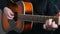 Young man plays the guitar, hands close up