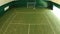 Young man plays tennis on a court