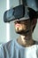 A young man plays a virtual game in VR glasses. home leisure on self-isolation at home. The virtual reality. portrait of handsome