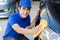 Young man polishing cleaning car with microfiber cloth