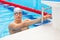 Young man in a pool - go to start swimming. backstroke during