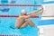 Young man in a pool - go to start swimming. backstroke during