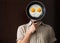 Young man portrait behind black pan with eggs