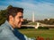 Young man posing in front of the Ulysses S. Grant Memorial, National Mall and Washington Monument in Washington DC