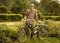 Young man posing with retro motorbike in the park.