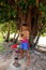 Young man pounding kava roots in Lavena village, Taveuni Island, Fiji