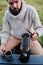 Young man pours coffee from a geyser coffee maker