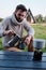 Young man pours coffee from a geyser coffee maker