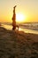 Young man practice balance asana on summer yoga session on beautiful golden beach of tropical island. Guy doing Salamba